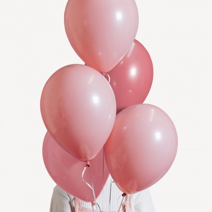 Woman with a pastel pink balloons set